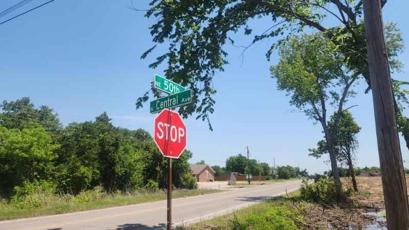 View of asphalt street with traffic signs