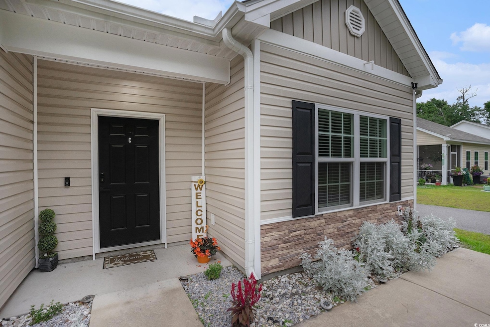 View of exterior entry with stone siding and board and batten siding