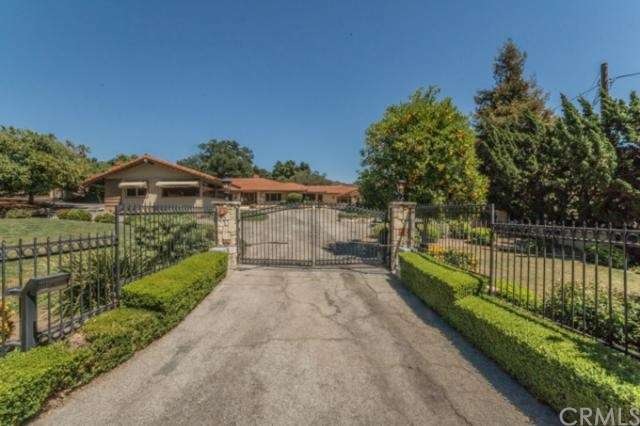 Front of house from street, beautiful rod iron gat