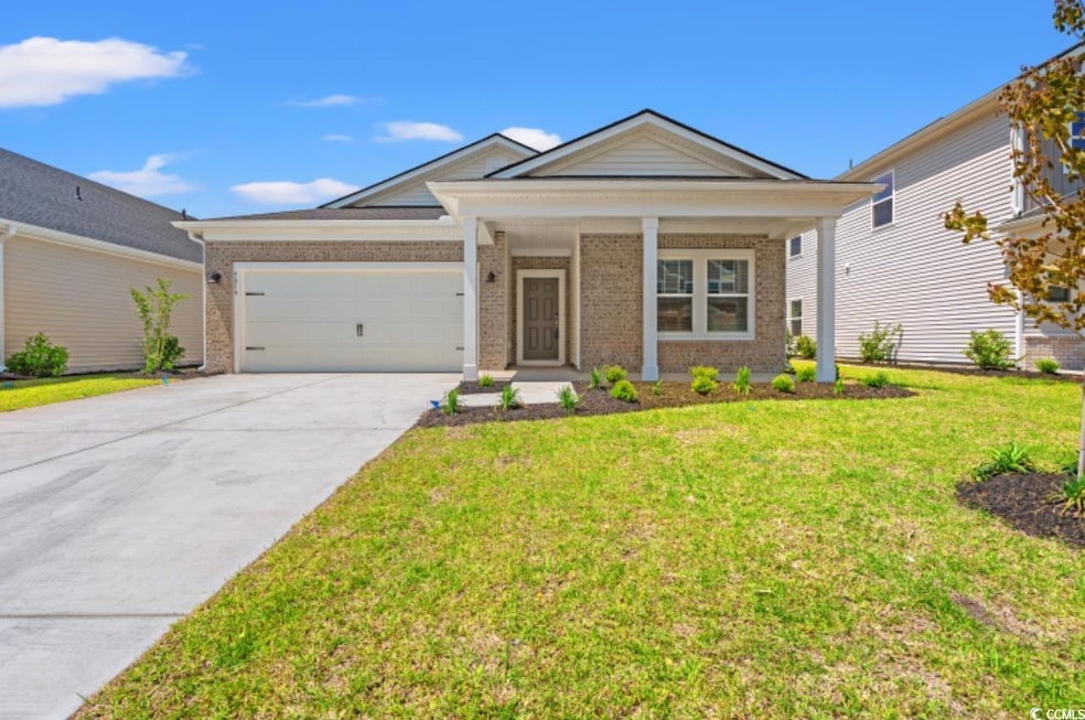 Ranch-style home with brick siding, an attached ga