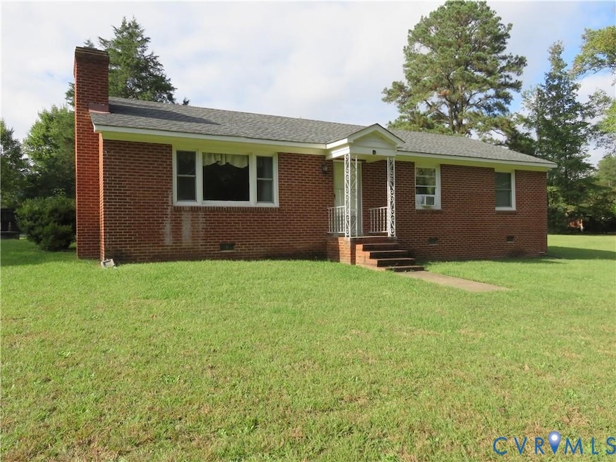 Single story home with crawl space, a front lawn, and brick siding