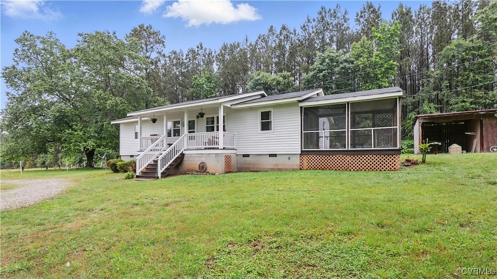 Rear view of property with crawl space, a yard, a