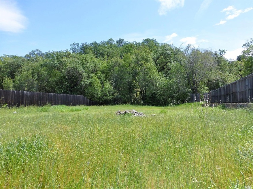 Borders seasonal creek and wooded hills at rear of