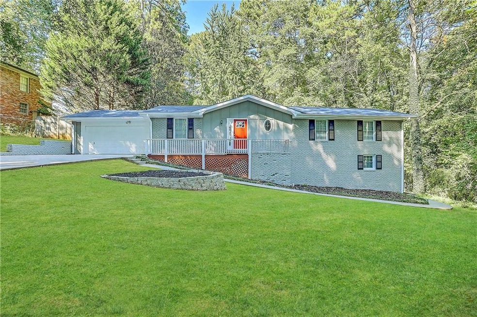 View of front of home with a front yard and a garage