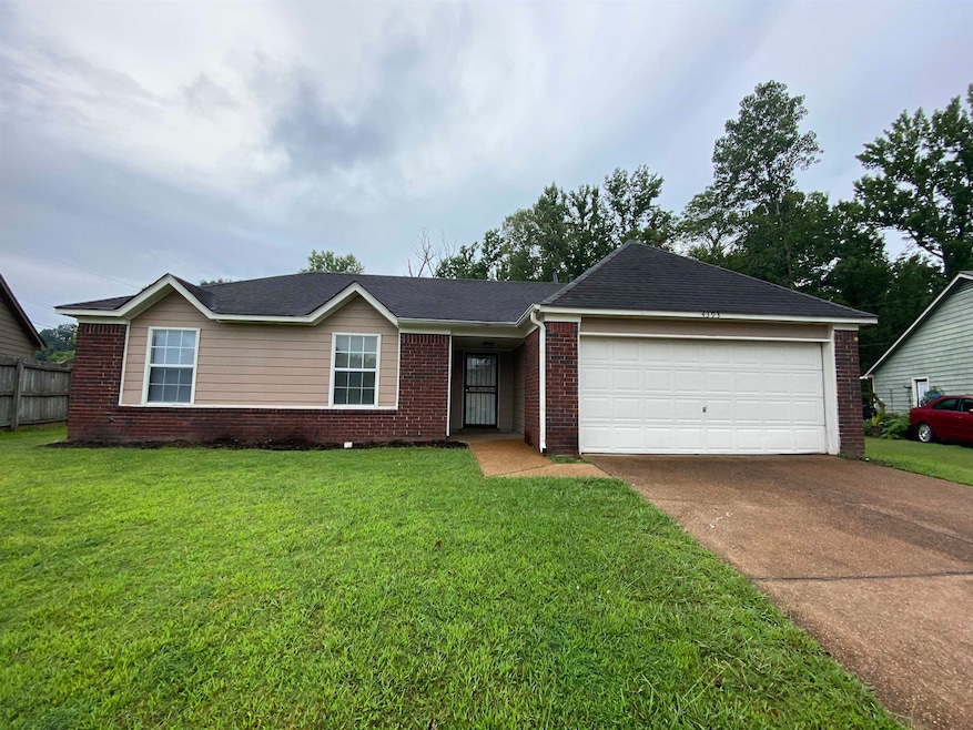 Single story home with a garage and a front yard