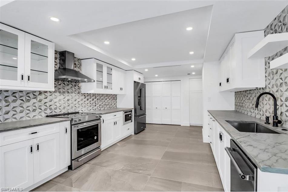 Kitchen with stainless steel appliances, wall chim