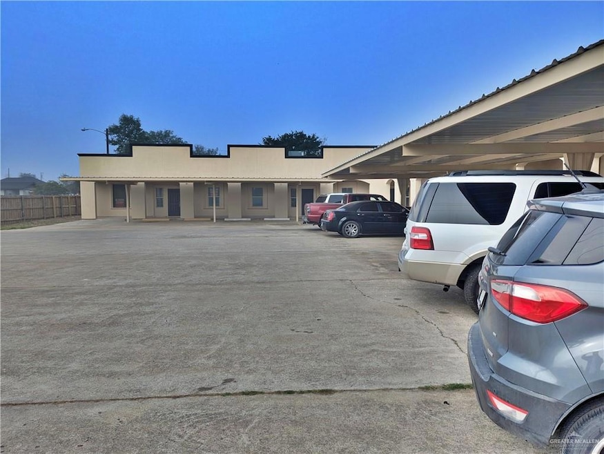 Partially covered parking lot featuring fence