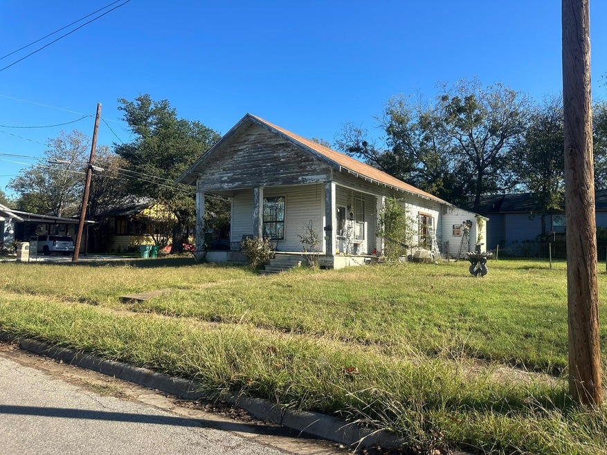 View of front of property with a front yard and covered porch