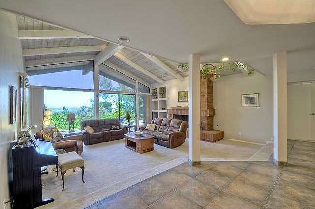 Huge dramatic step down living room.  Wood beamed 