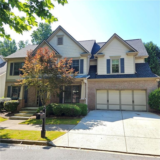 Craftsman-style house featuring brick siding, driveway, a garage, and roof with shingles