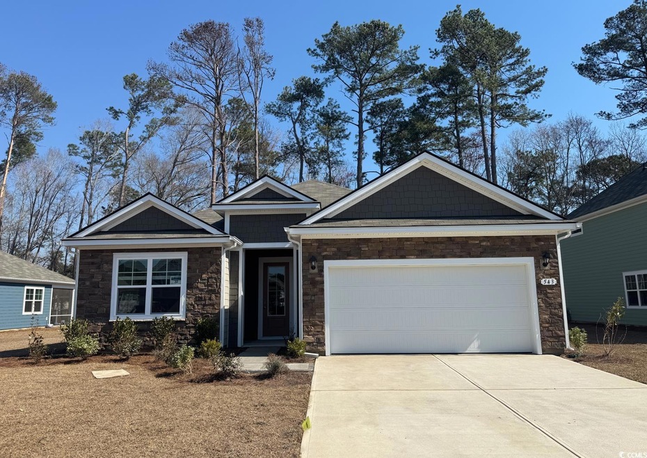 Craftsman inspired home with a garage, stone sidin