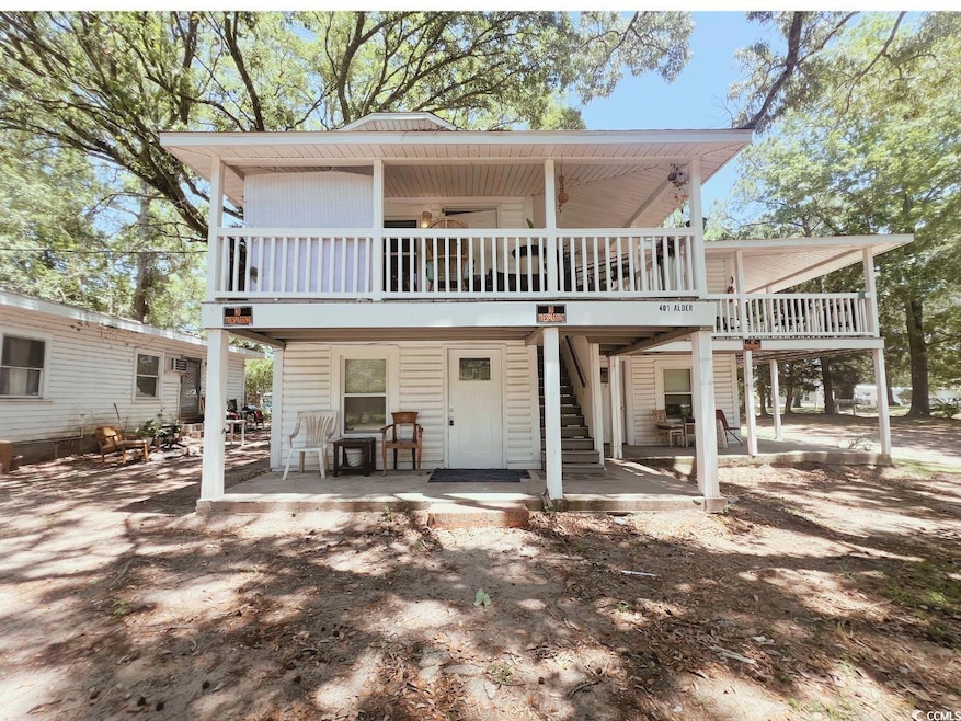 Back of house featuring a patio, a deck, and stair