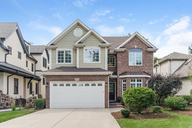 A beautiful brick and cedar home with brick paver 