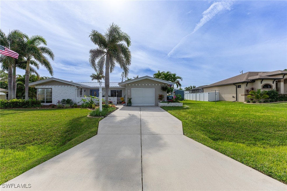 Ranch-style house with a front yard and a garage