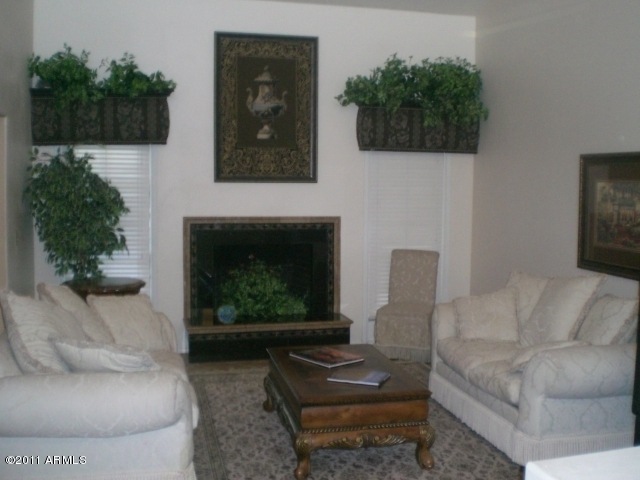 LIVING ROOM HAS A COZY FIREPLACE