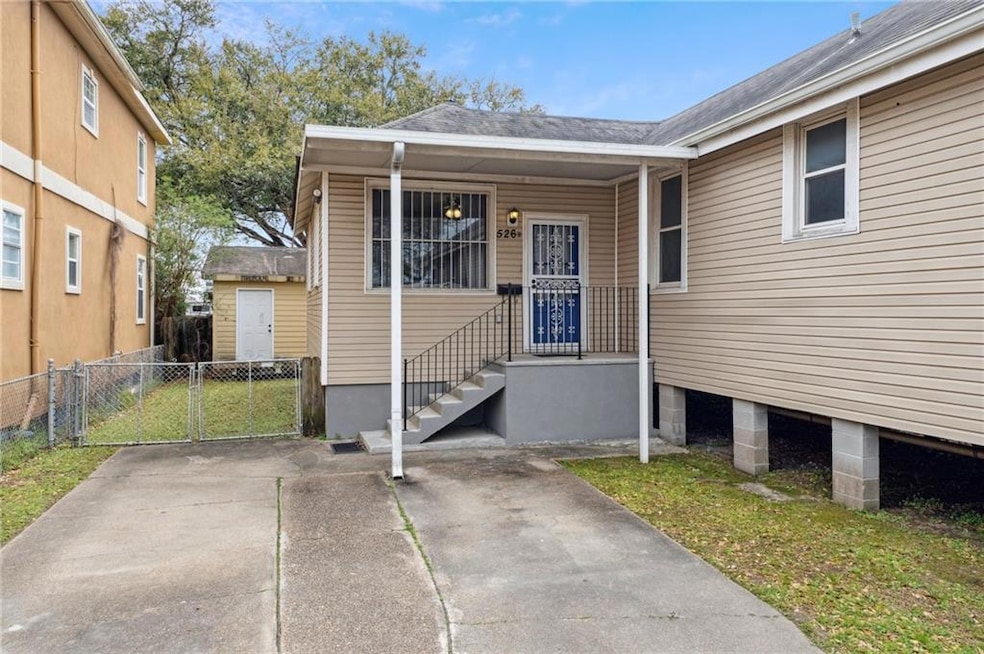 Welcome to rhe charming porch and entrance for Unit B at 526 South Saint Patrick street. The white security door is perfect for keeping furry friends inside while enjoying the fresh air and the breeze!