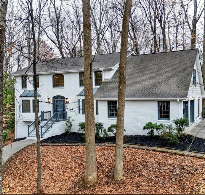 View of front facade with brick siding and roof wi