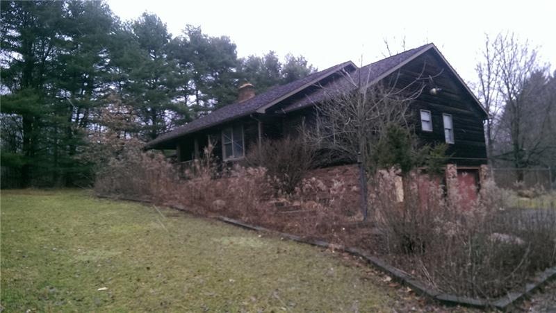 Once landscaped with mature shrubbery. Fenced in r