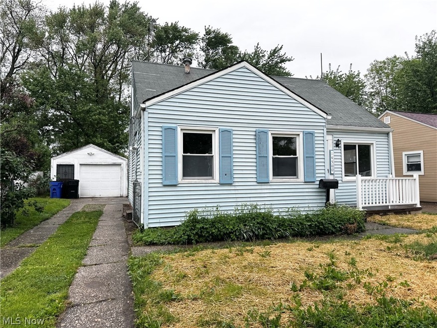 Bungalow-style home featuring a garage and an outdoor structure