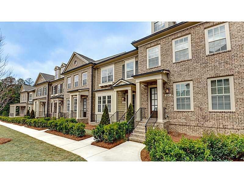 Facade/Exterior Front. Brick Exterior. Green court
