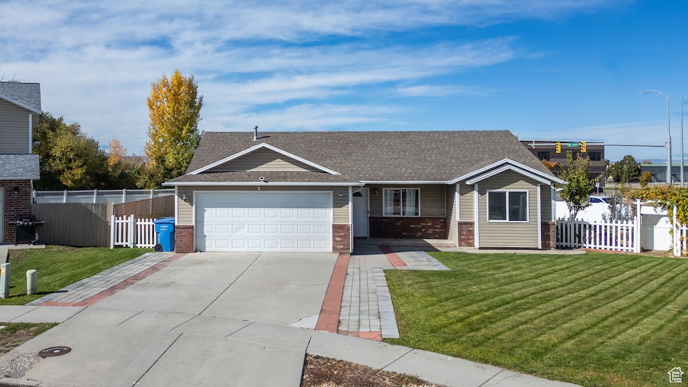 Single story home featuring a porch, concrete driveway, a shingled roof, brick siding, and a garage