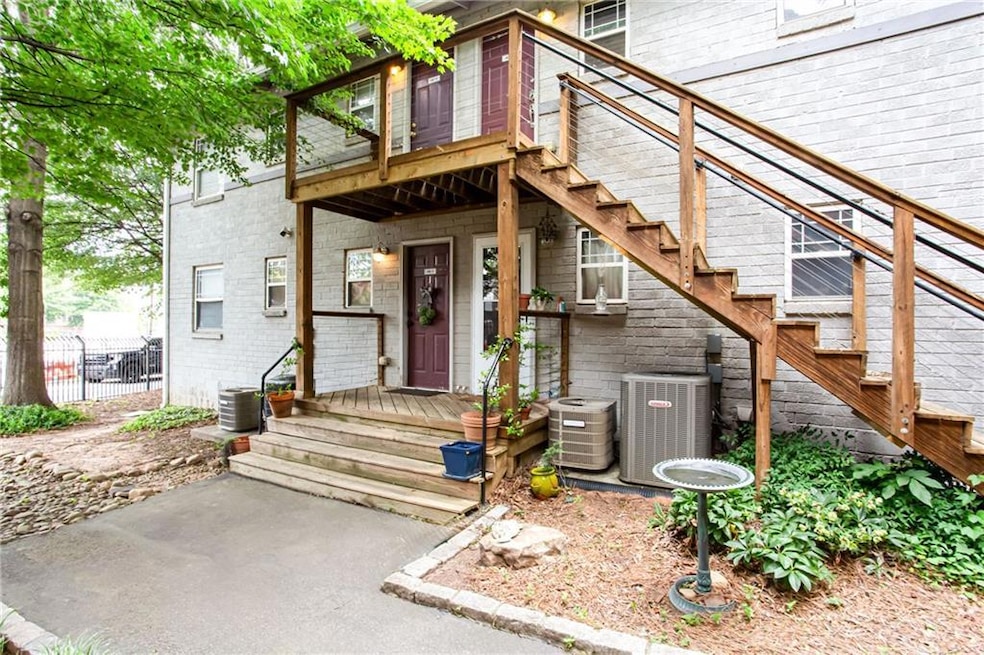 Property entrance featuring central air condition unit and stone siding