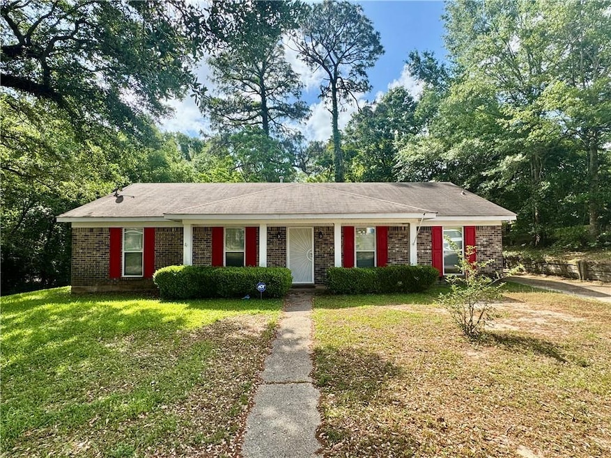 Single story home with brick siding and a front la
