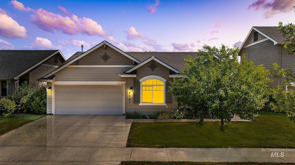 Craftsman inspired home with an attached garage, concrete driveway, and a front yard
