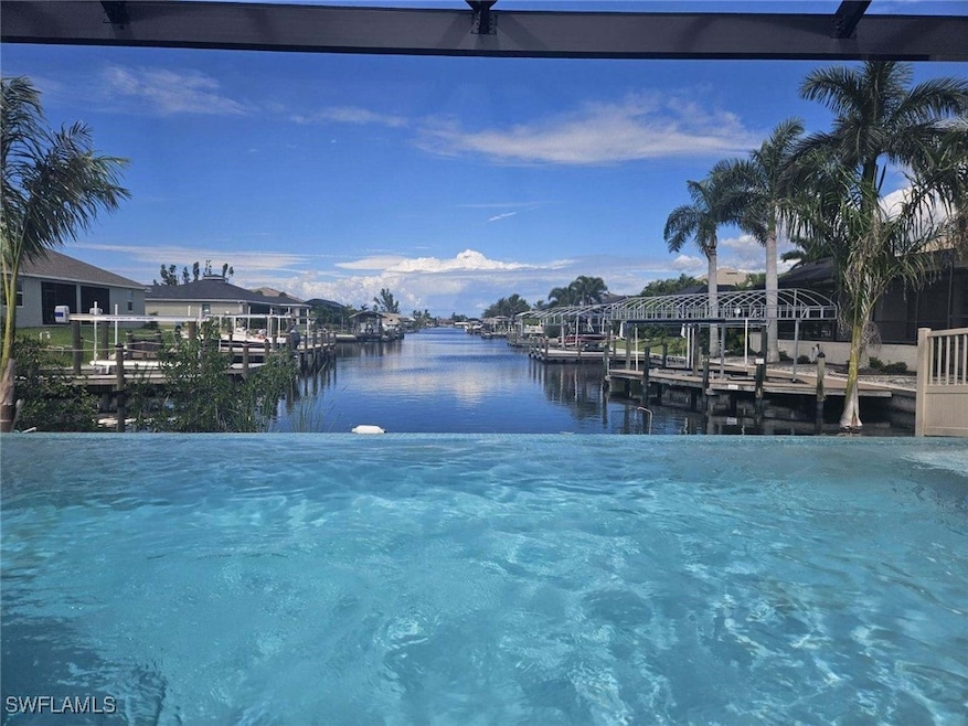 View of swimming pool with a dock and a water view
