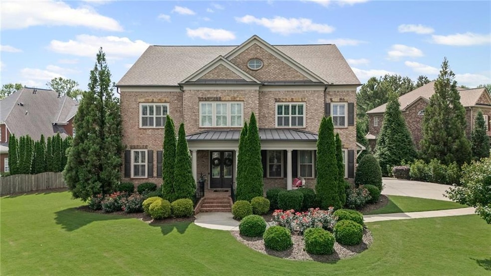 Colonial inspired home featuring brick siding and a standing seam roof
