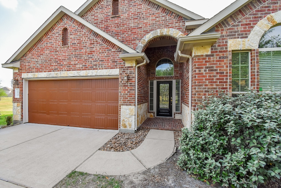 Charming brick exterior with an inviting arched en