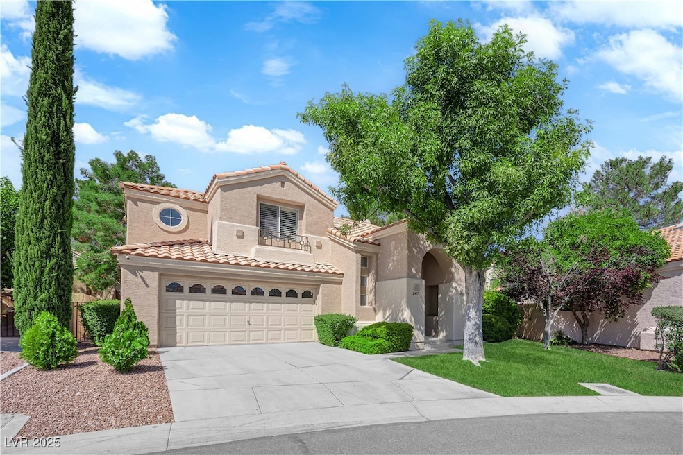 Mediterranean / spanish house with a tile roof, concrete driveway, stucco siding, a front lawn, and a balcony
