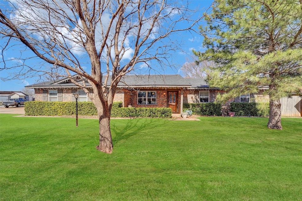 Ranch-style Brick home and a front yard. Evergreen