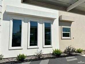 View of side of home with stucco siding