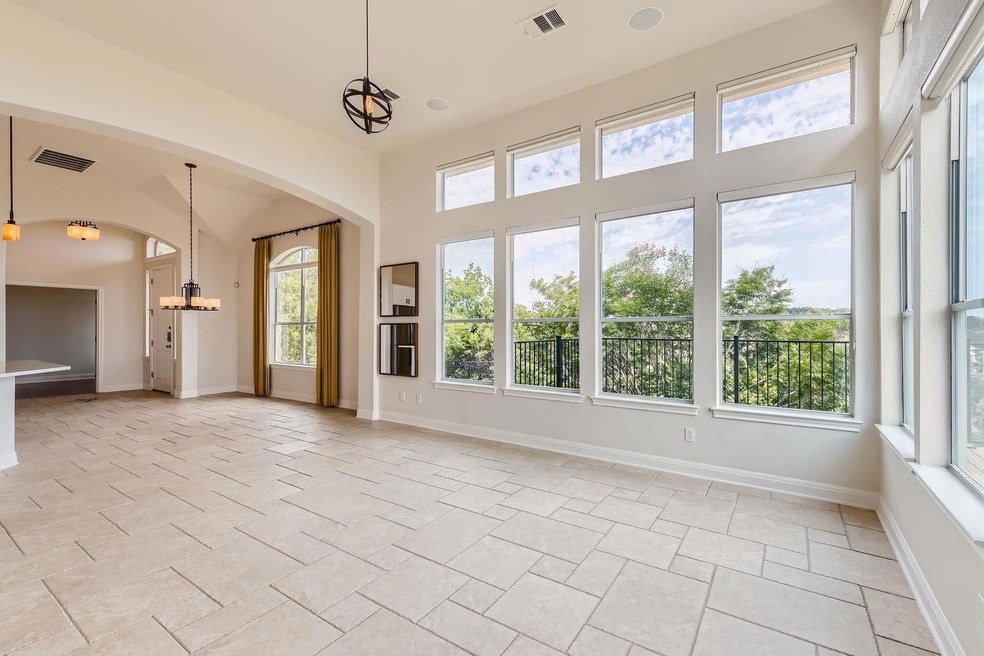 Empty room with arched walkways, baseboards, and 