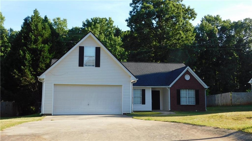 View of front of house with a garage and a front y