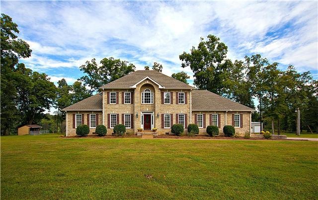 Beautiful custom all brick home, 16.39 fenced & cross fenced acres, stocked lake, 50 x 60 metal insulated building, cottage & small metal barn.  Your own private showplace.