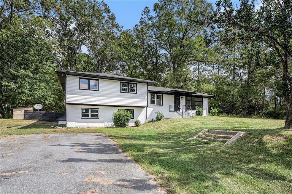 Tri-level home featuring a front lawn