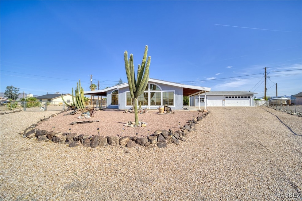 View of front of home with a garage and fence