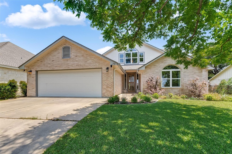 Traditional home featuring driveway, a garage, an