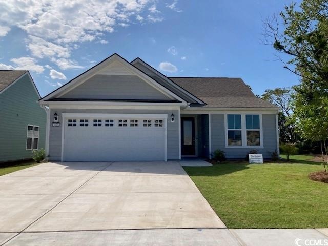 View of front of home with a garage and a front la