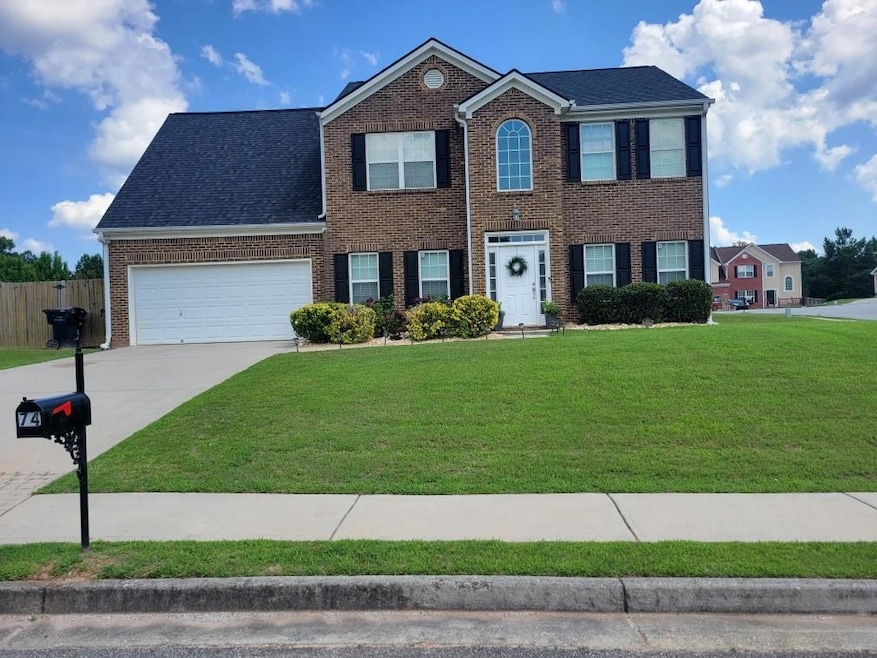 Colonial-style house featuring a front lawn and a 