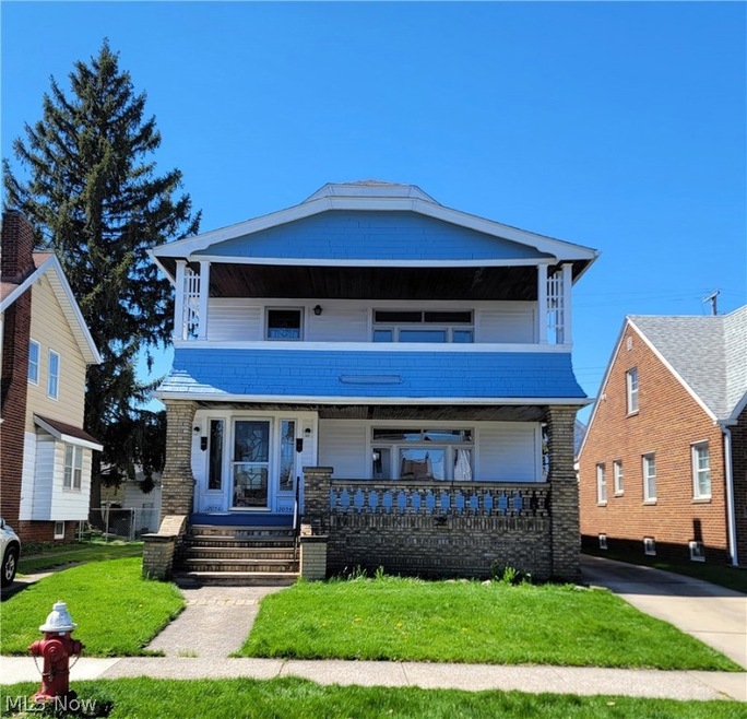 View of front of house with a front lawn and a porch