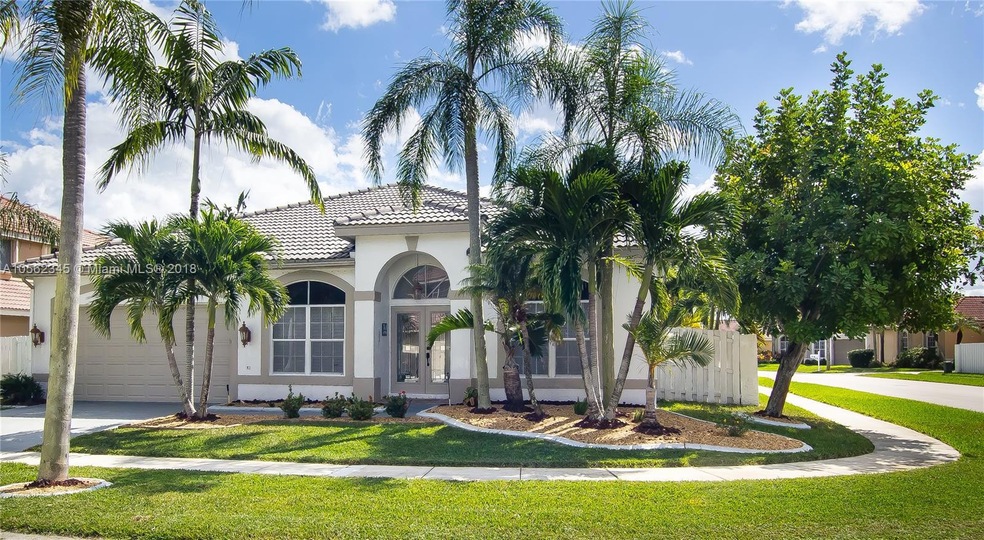 beautifully manicured corner lot with lush landscaping 