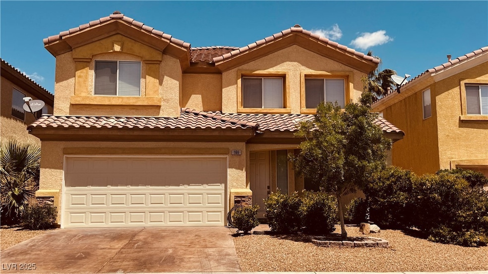 View of front of home featuring a tiled roof, driv