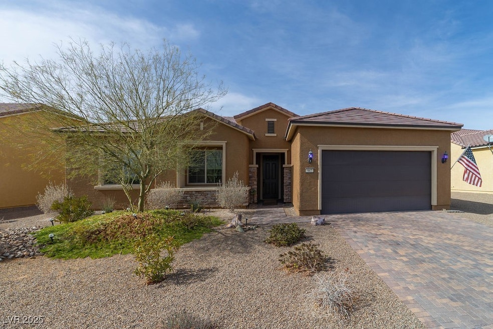 Single story home with a garage, a tiled roof, dec