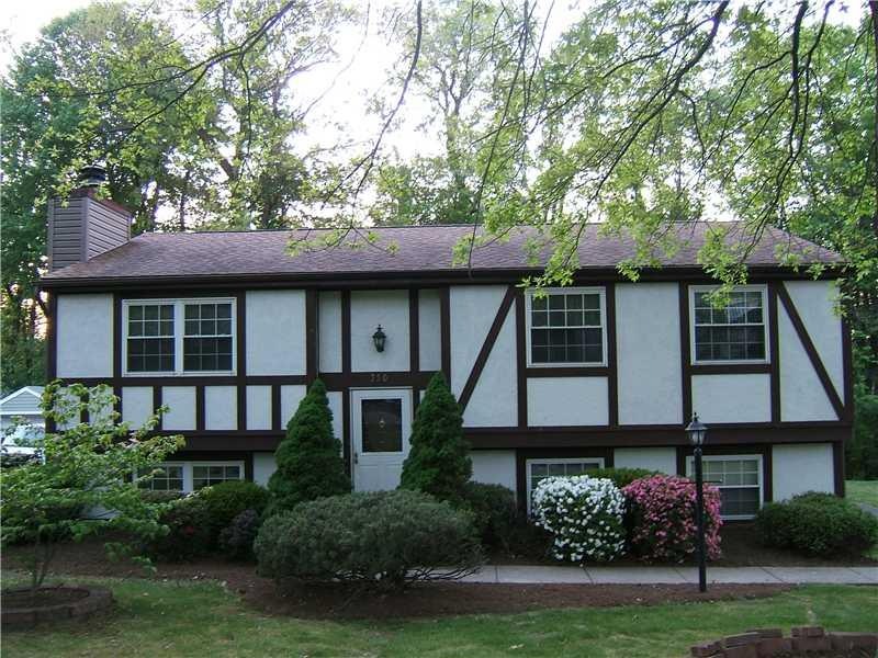 Exterior Front. This Tudor Split Entry Features Br