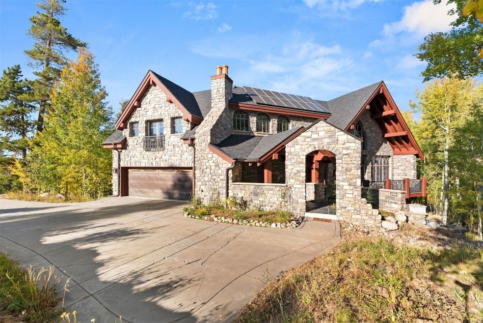 View of front of house with a garage and solar panels