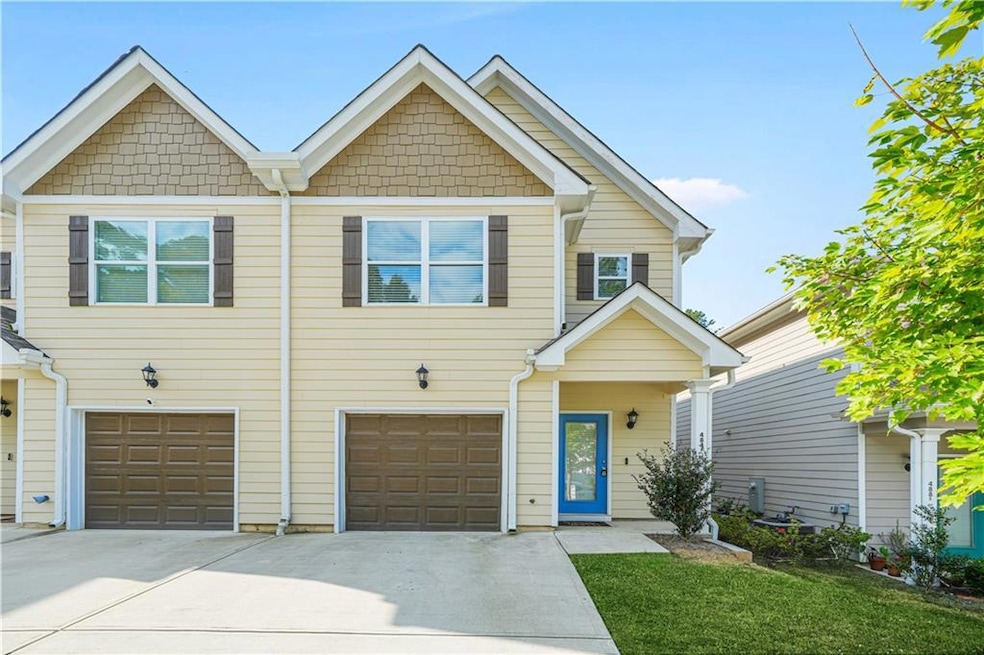 View of front of house featuring concrete driveway and a garage