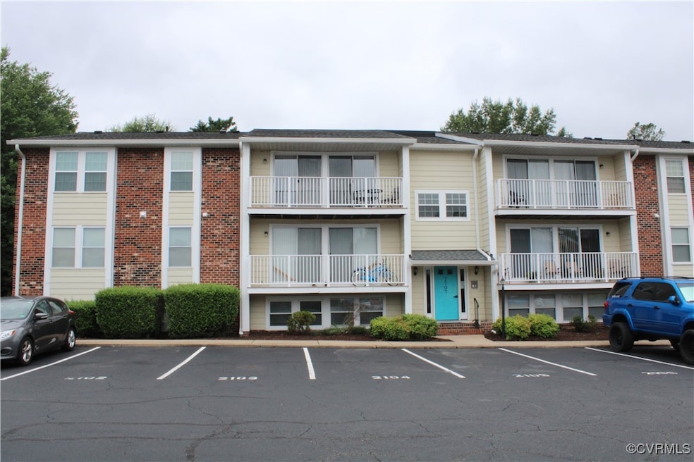 View of property featuring uncovered parking